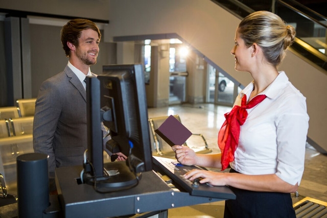businessman-interacting-with-female-airport-staff-check-desk-107420-85039